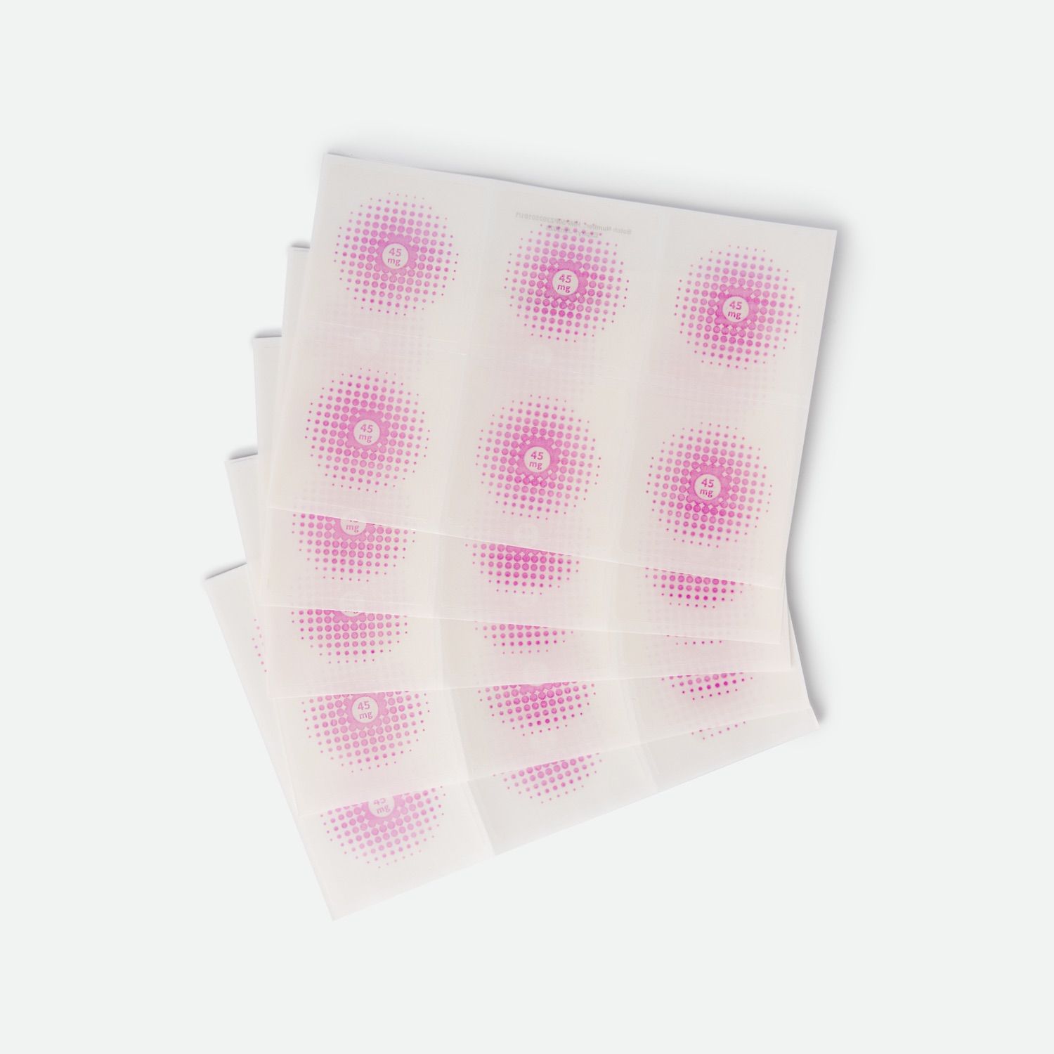 Mehrere quadratische Pflaster mit rosa Punktmuster. Jedes Pflaster hat einen rosa Kreis in der Mitte.