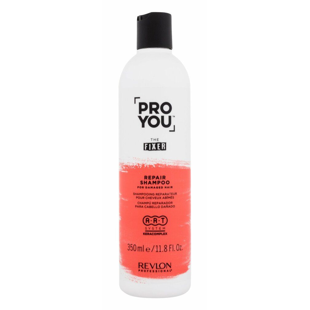 Weiße Flasche mit schwarzem Deckel. Aufschrift: PRO YOU THE FIXER REPAIR SHAMPOO. Rote Farbfläche. Revlon Professional.