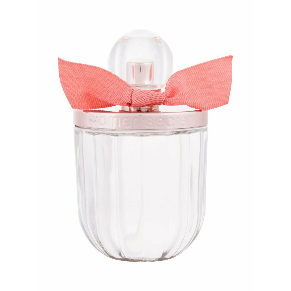 Glasflakon mit rosa Schleife. Der Flakon hat einen runden Deckel und einen geriffelten Körper. Auf dem Deckel steht "women secret".
