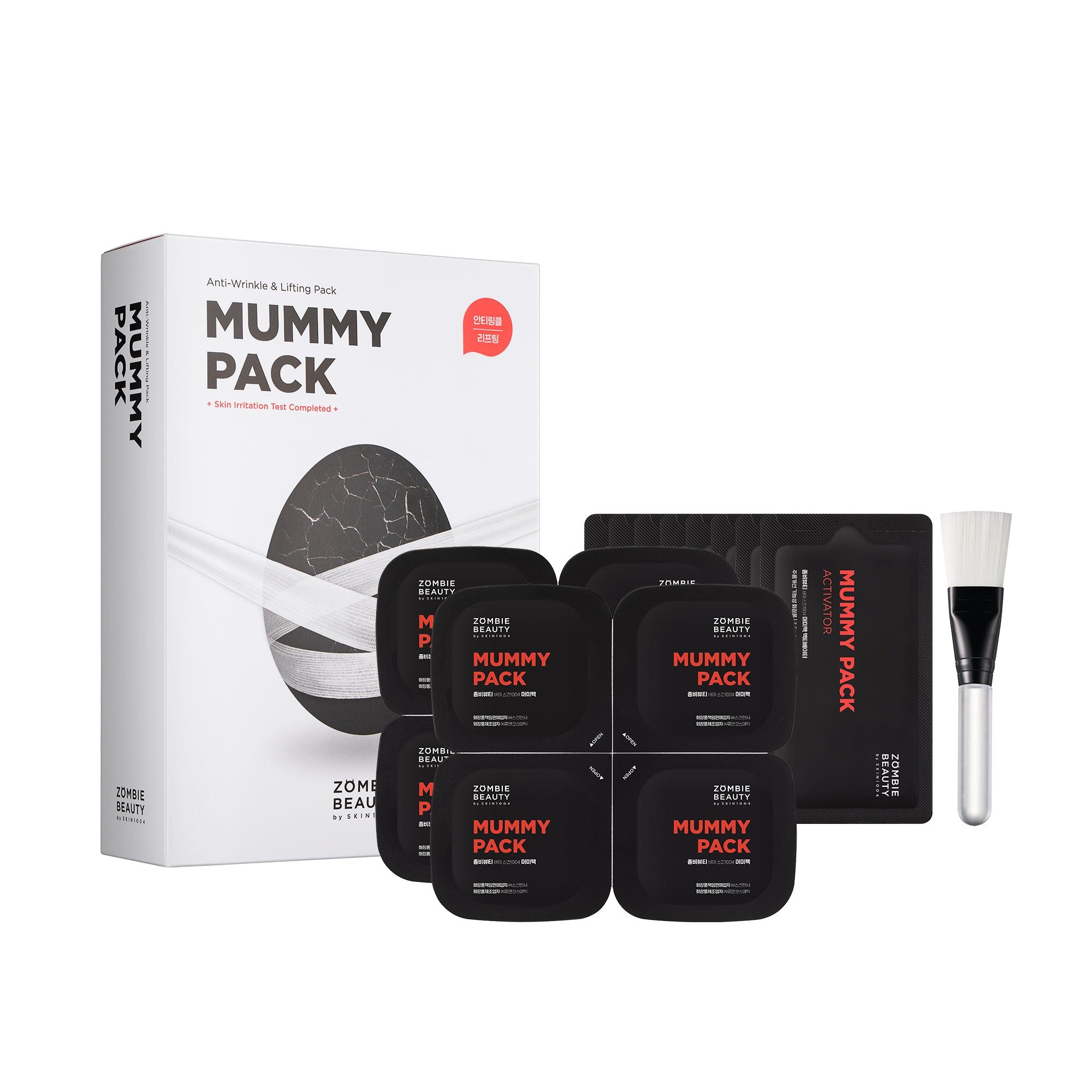Verpackung mit "Mummy Pack"-Schriftzug, mehrere Einzelpackungen, Pinsel. Schwarze und rote Akzente. Marke: ZOMBIE BEAUTY.