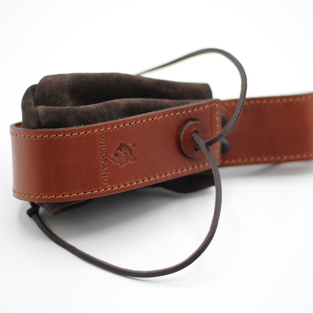Braune Ledertasche mit Wildfang-Logo und Kordelzug. Detail: brauner Lederriemen.