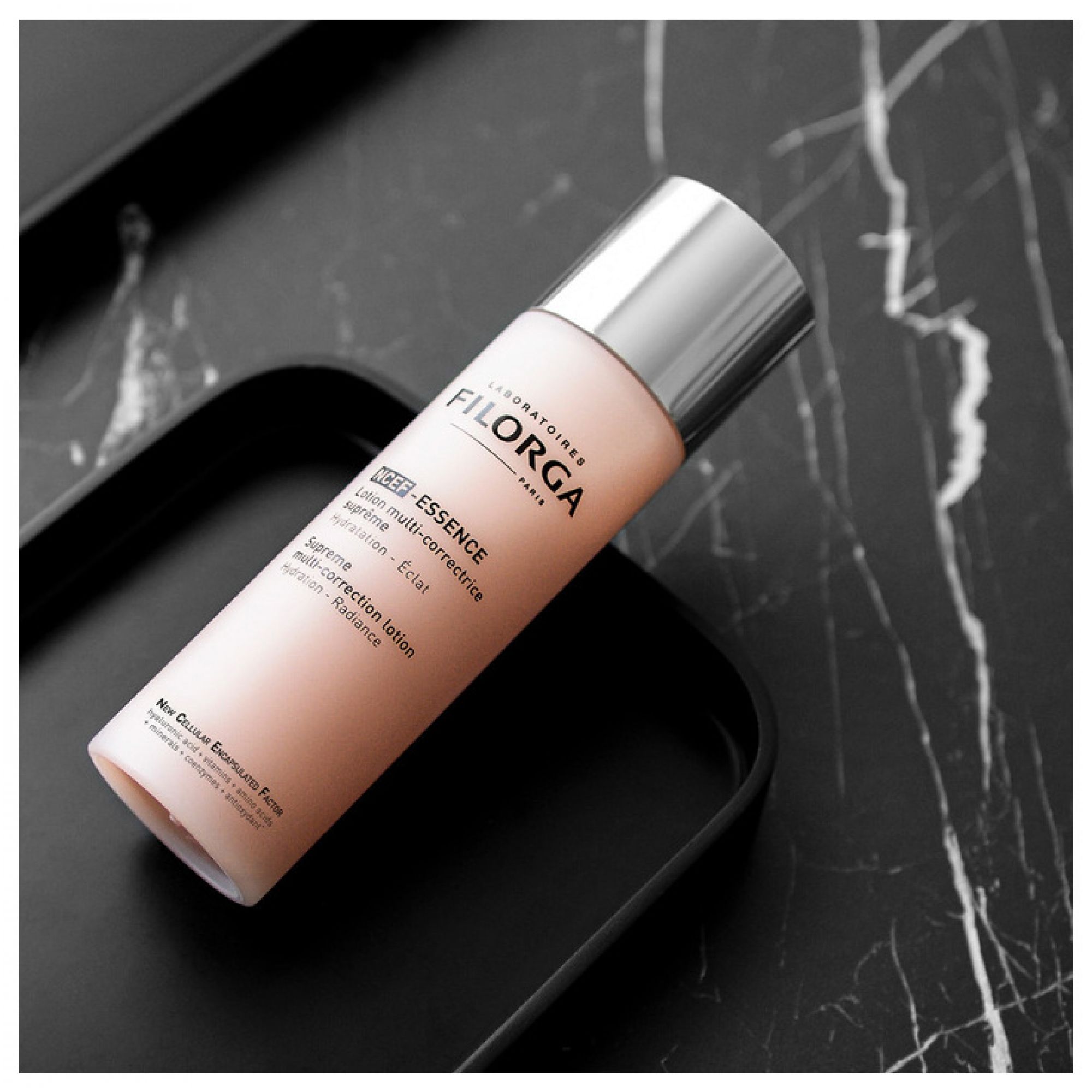 Filorga NCEF Essence Lotion auf schwarzer Unterlage.