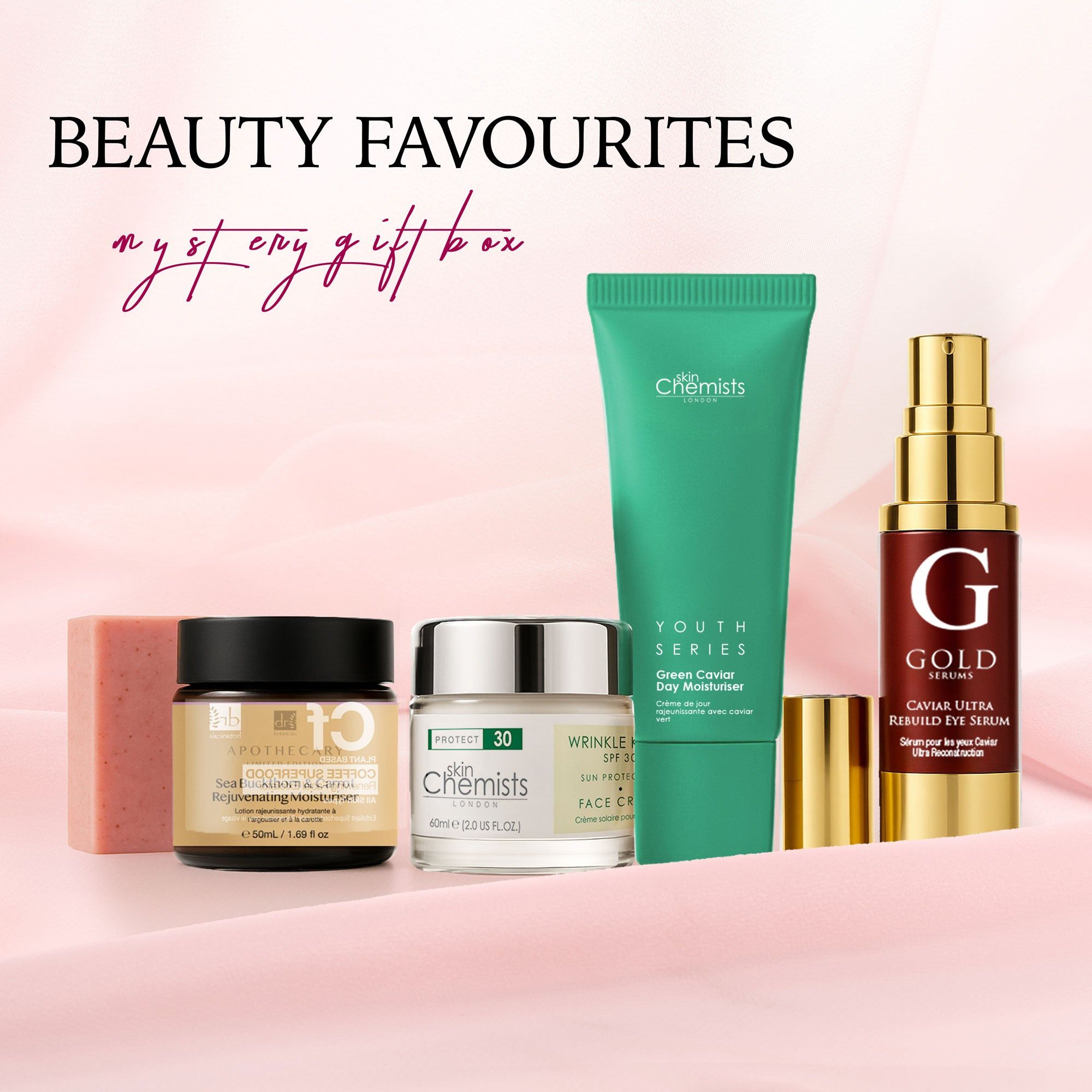 Geschenkbox mit Hautpflegeprodukten. Enthalten sind Cremes, Serum, Seife und eine Tube. Marken: SkinChemists, Apothecary, Gold Serums.