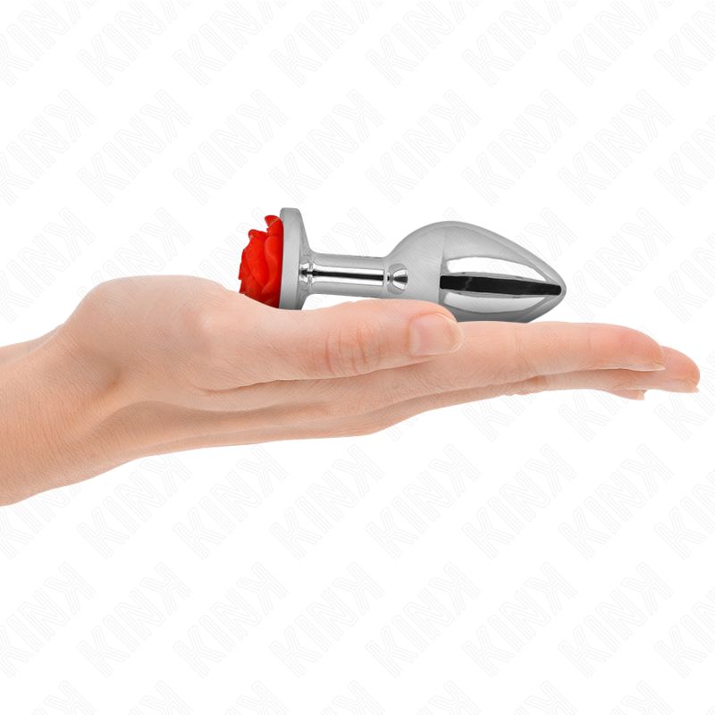 Metall-Analplug mit roter Rose in einer Hand.