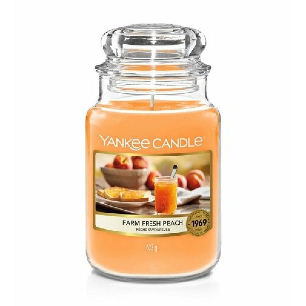 Duftkerze im Glas mit Deckel. Etikett mit Pfirsich-Motiv und Schriftzug "Yankee Candle". Gewicht: 623g.