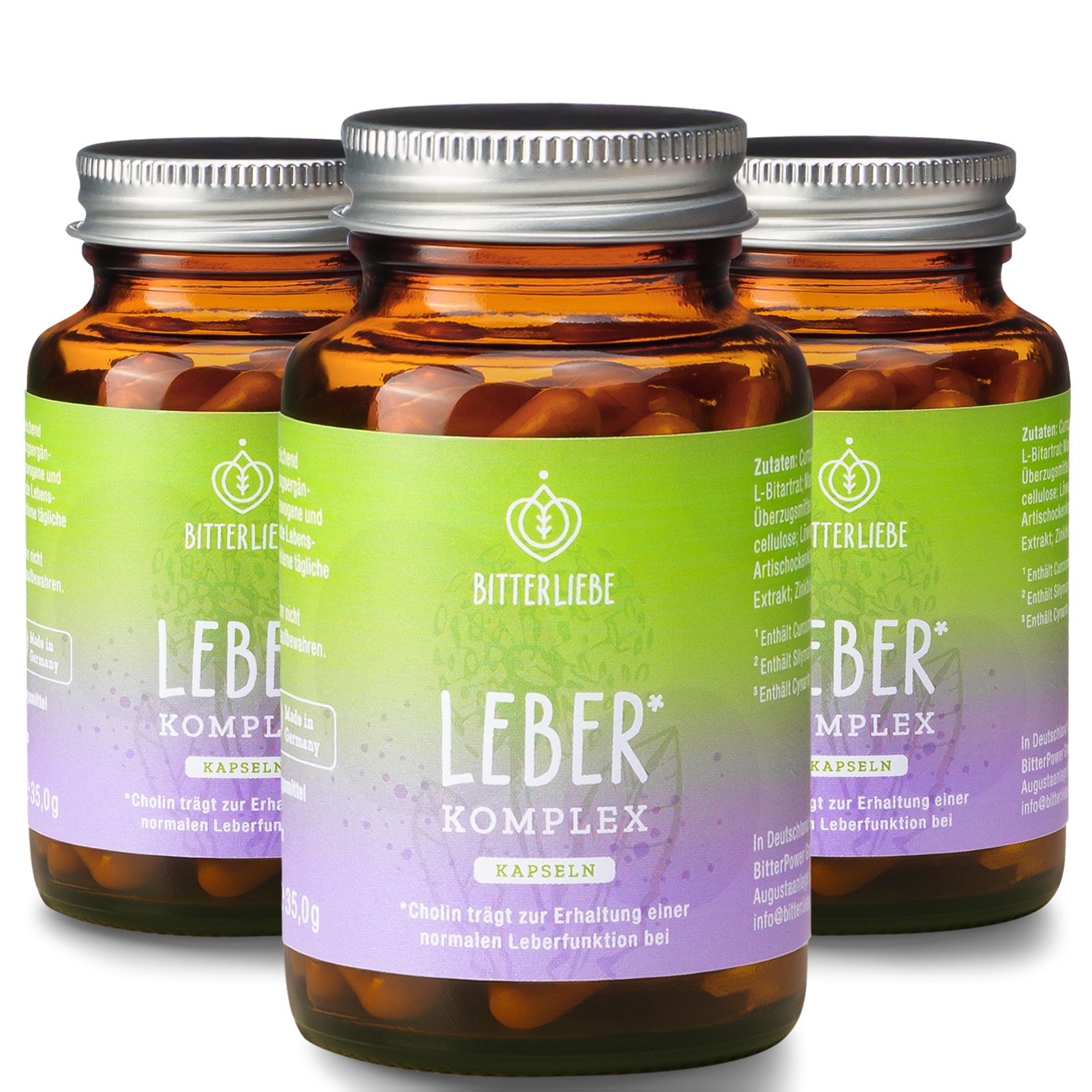 Drei braune Glasflaschen mit silbernen Deckeln. Etiketten mit Text und Logo. Kapseln sichtbar.