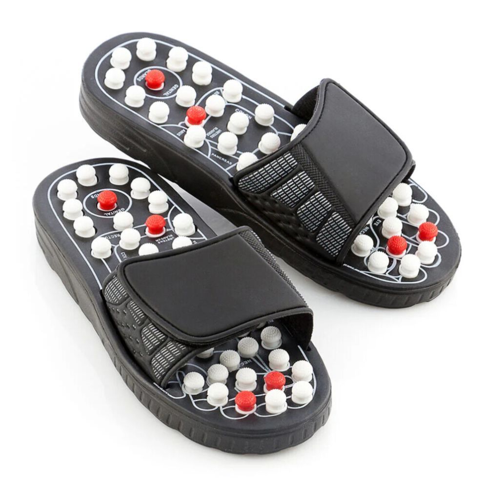 Schwarze Akupunktur-Schuhe mit weißen und roten Noppen. Verstellbarer Riemen. Oberseite mit Noppenmuster.