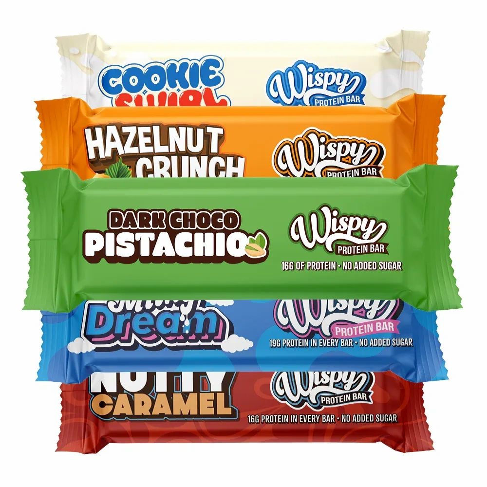 Fünf Wispy Protein Riegel in verschiedenen Geschmacksrichtungen: Cookie Swirl, Hazelnut Crunch, Dark Choco Pistachio, Milky Dream, Nutty Caramel.