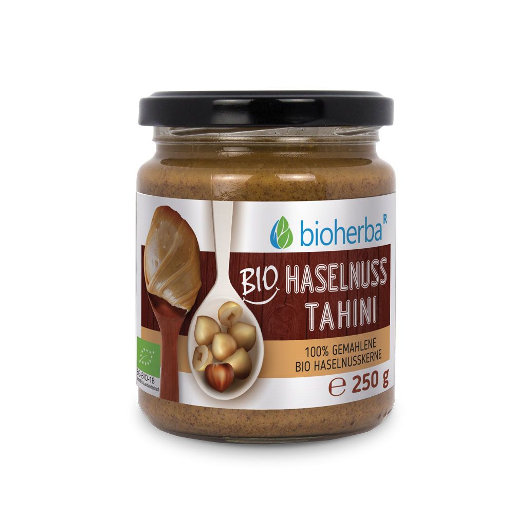 Glas mit Bio Haselnuss Tahini. Schwarzer Deckel, Etikett mit Produktinformationen und Bio-Siegel. Enthält 250g.