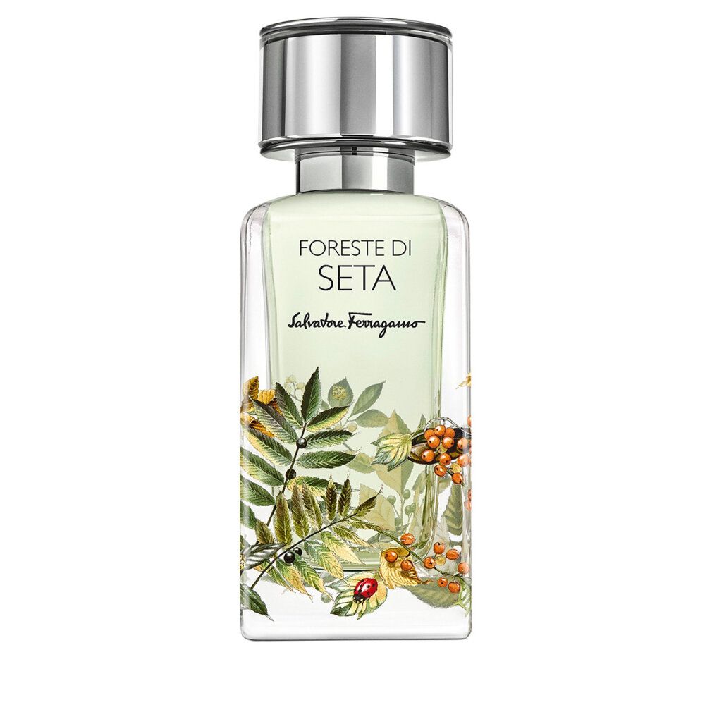 Parfümflakon mit silbernem Verschluss und botanischem Aufdruck.