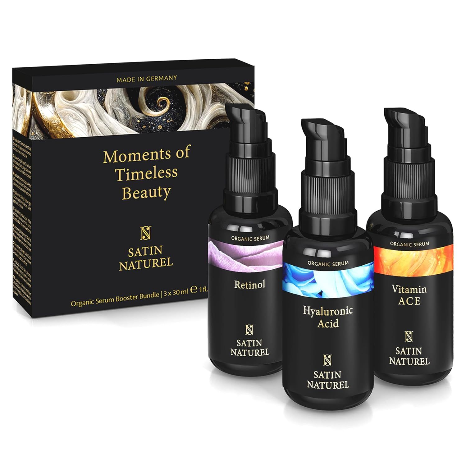 Schwarze Geschenkbox mit drei Serumflaschen. Aufschriften: Retinol, Hyaluronsäure, Vitamin ACE. Text: Moments of Timeless Beauty.