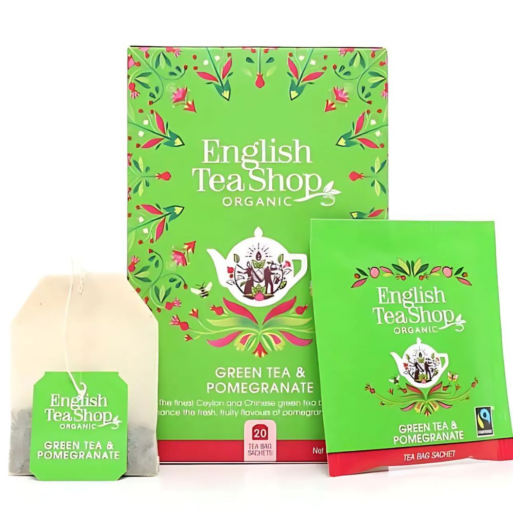 Box und Teebeutel mit 'English Tea Shop Organic'. 20 Teebeutel. Teebeutel mit Aufschrift 'Green Tea & Pomegranate'.
