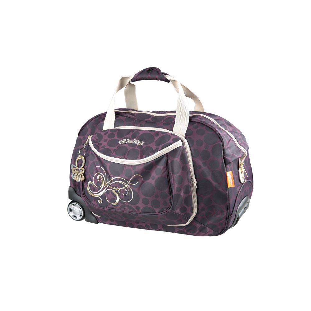 Reisetasche mit Rollen, lila mit schwarzen Punkten. Beige Details, goldene Verzierungen und Okiedog-Logo. Zwei Rollen.