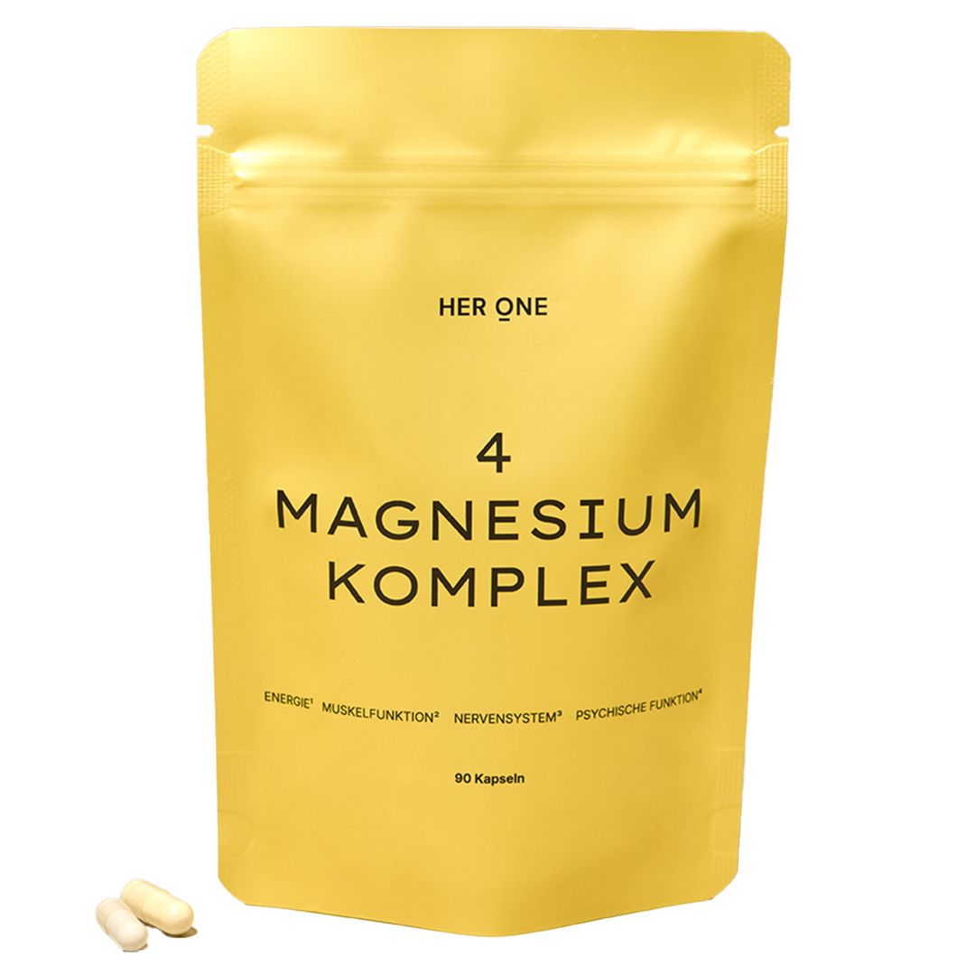 Gelbe Verpackung mit Aufschrift HER ONE 4 MAGNESIUM KOMPLEX. Enthält 90 Kapseln. Zwei Kapseln liegen daneben.