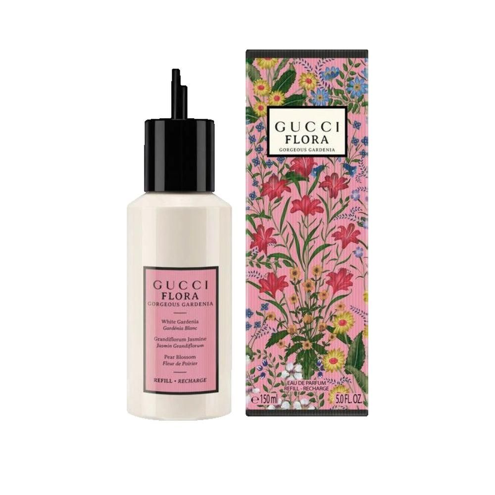 Weißer Flakon mit schwarzem Verschluss und rosa Etikett. Daneben eine Schachtel mit floralem Design und Produktnamen.