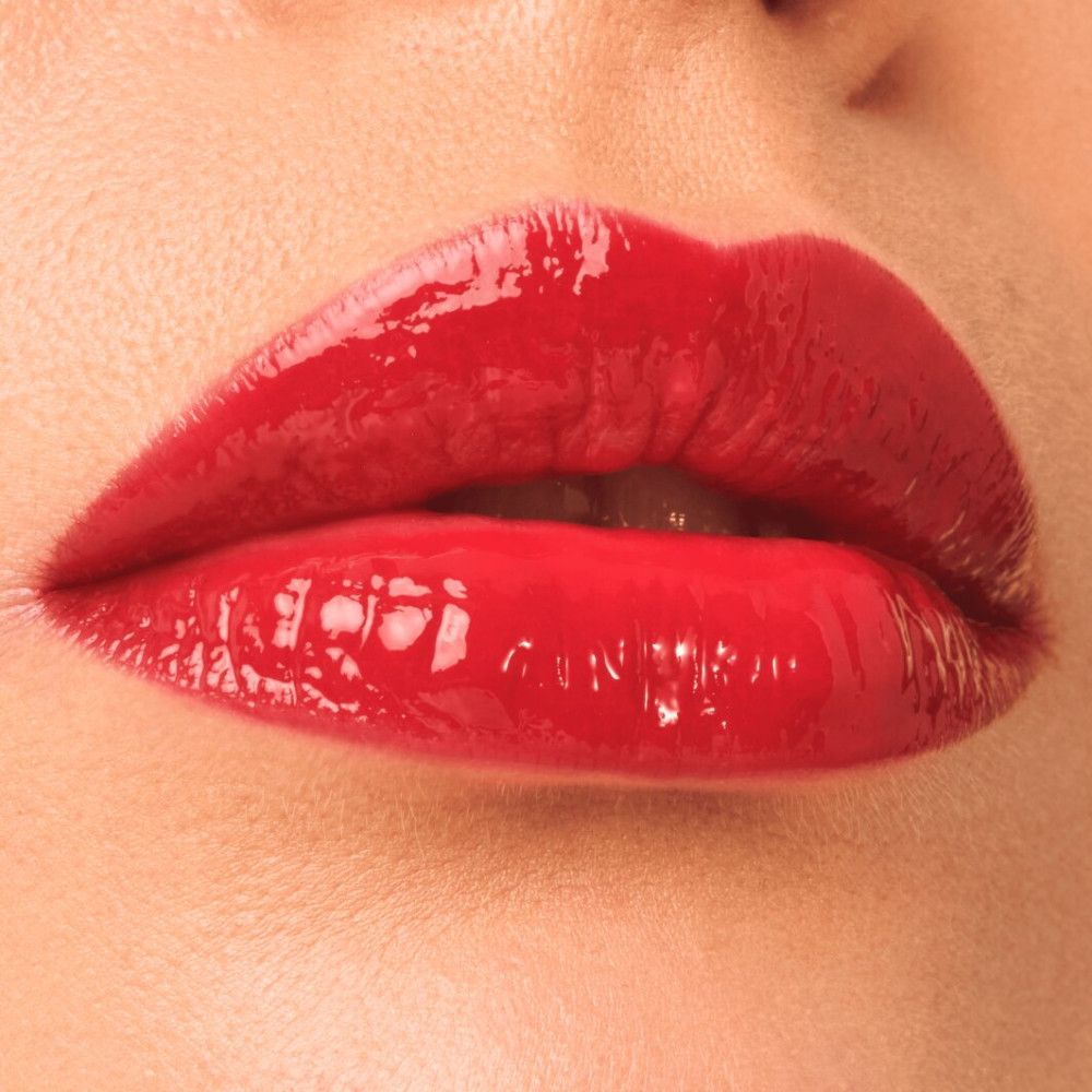 Nahaufnahme von Lippen mit rotem Catrice Colour Glaze Lip Tint. Glänzendes Finish.