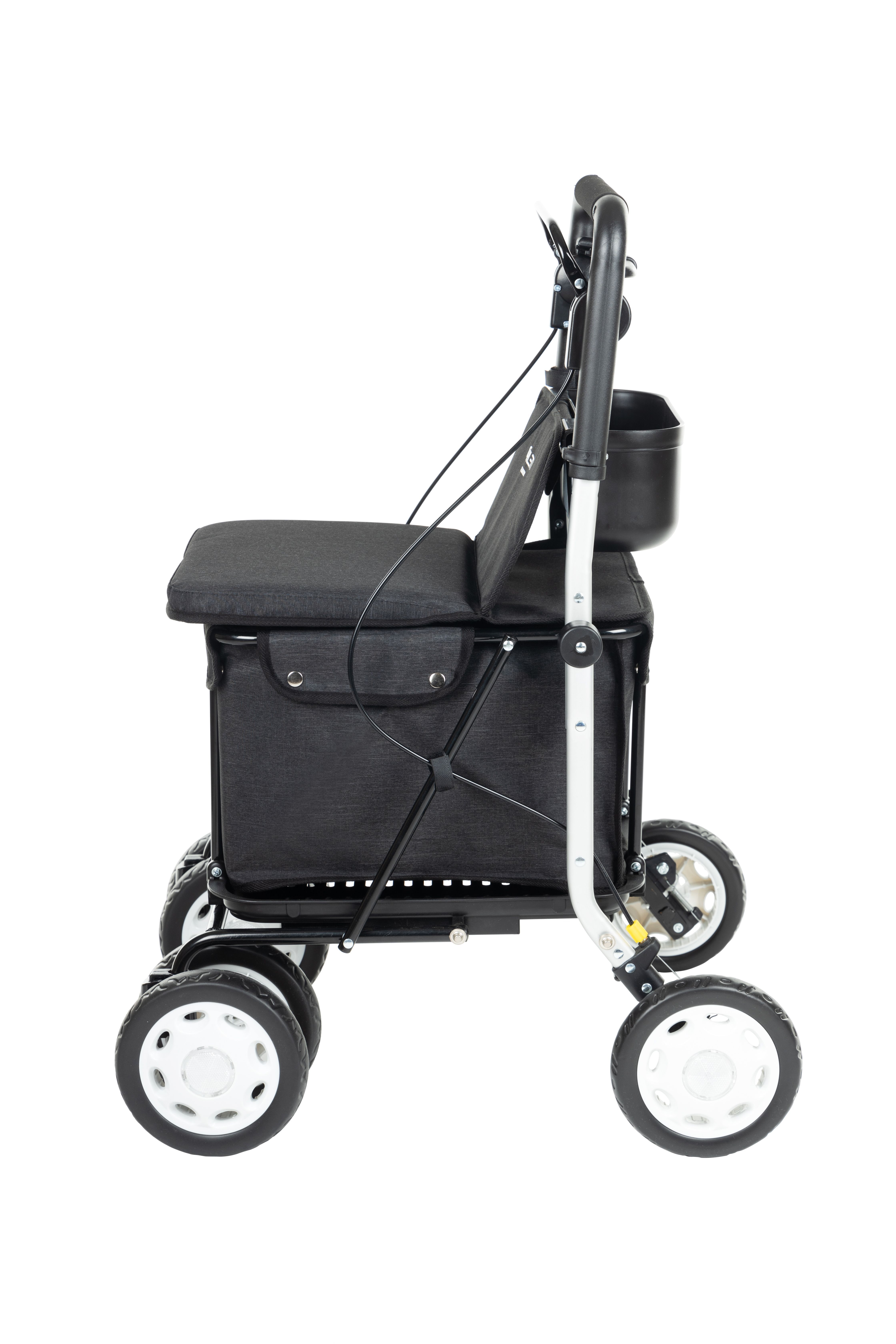 Gehstock mit Sitz. Schwarzes Gestell, grauer Sitz und Tasche. Seitenansicht. Korb und Halterung.