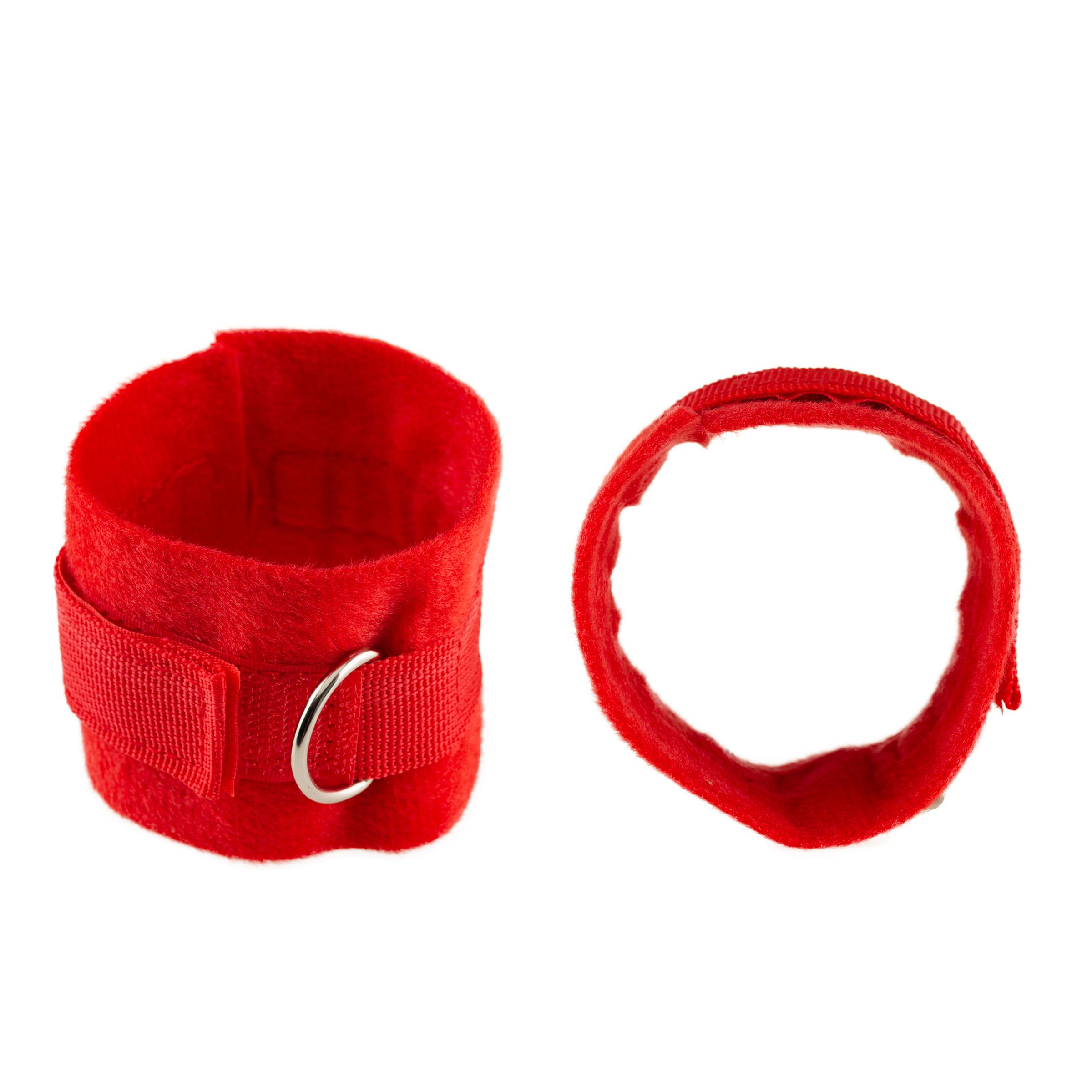 Zwei rote Handfesseln aus Stoff mit Klettverschluss und Metallringen.