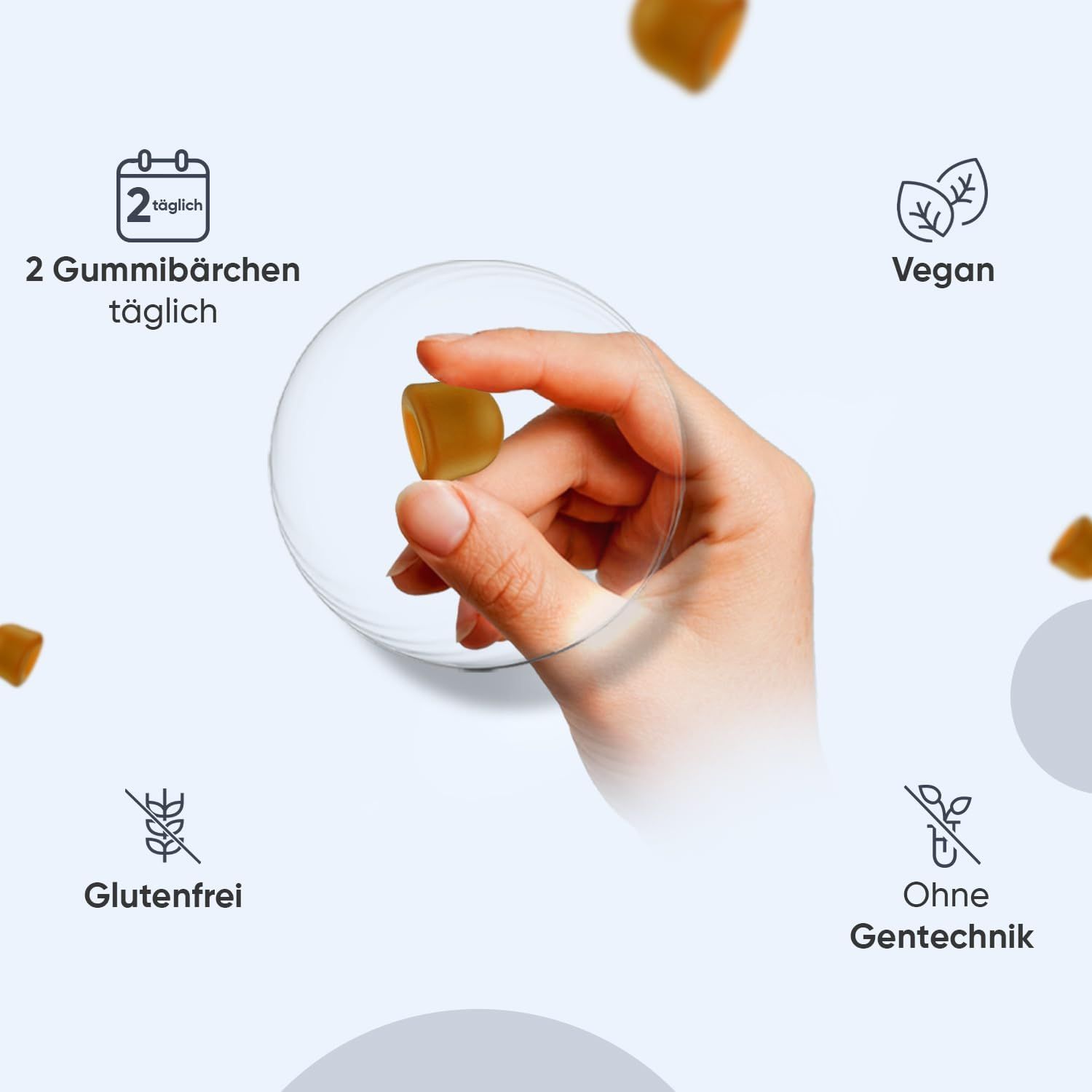 Hand hält ein Gummibärchen. Auf dem Bild sind Symbole für: 2 Gummibärchen täglich, vegan, glutenfrei, ohne Gentechnik.