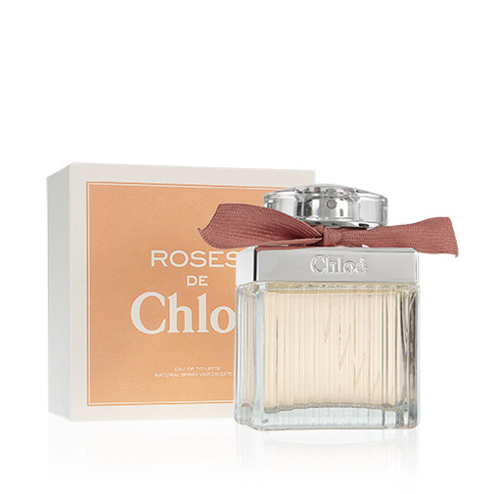 Parfümflakon mit Verpackung. Rechteckiger Glasflakon mit rosa Schleife. Verpackung mit Schriftzug 'Roses de Chloé'.