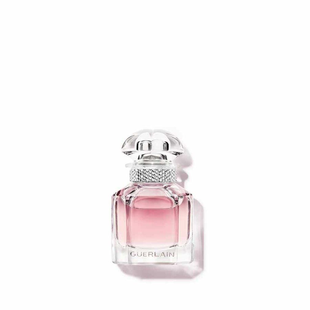 Kleine rosa Parfümflasche mit transparentem Deckel und Strass. Guerlain-Logo auf der Vorderseite.
