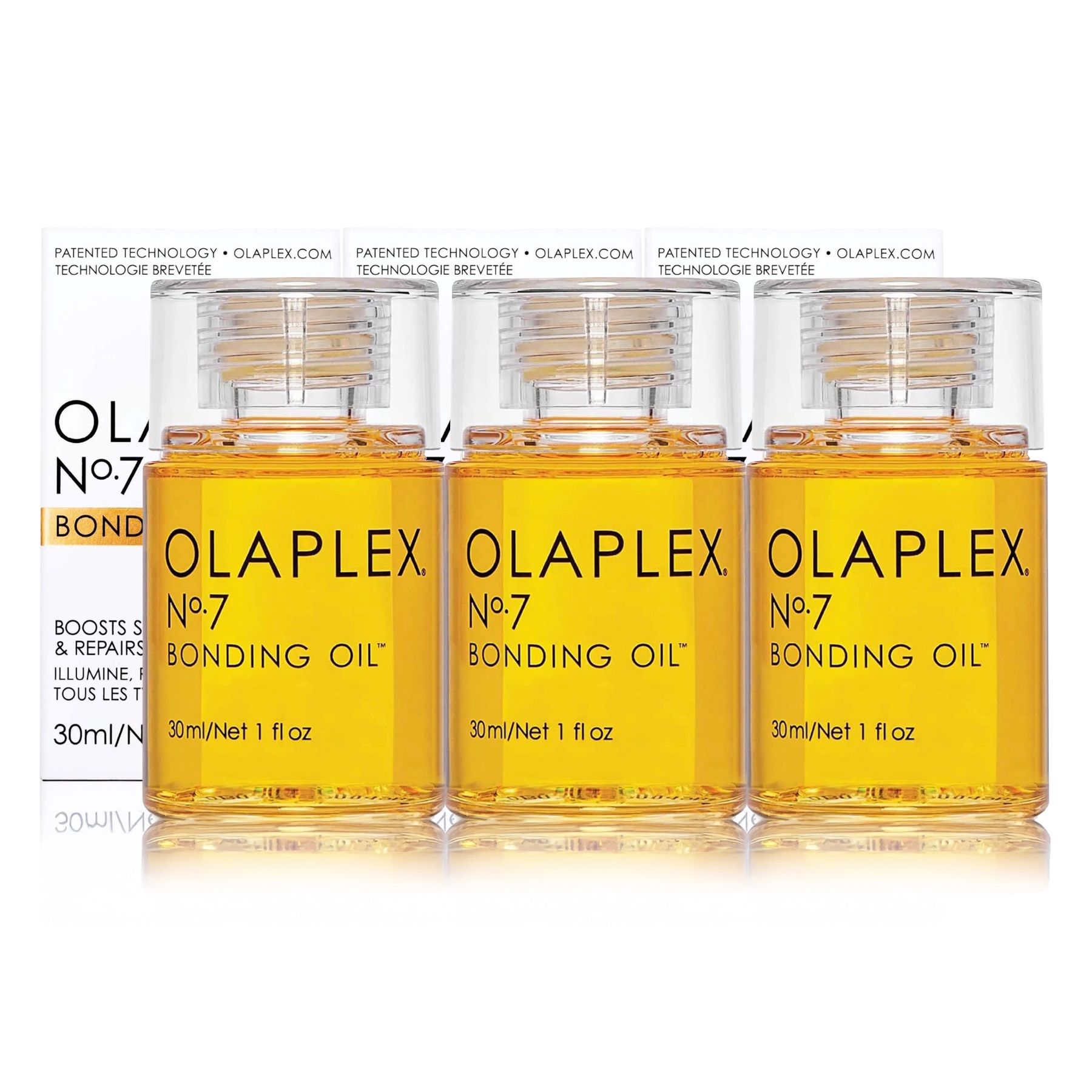 Drei Flaschen Olaplex Nr. 7 Bonding Oil. Gelbe Ölflaschen mit Text. Verpackung im Hintergrund.