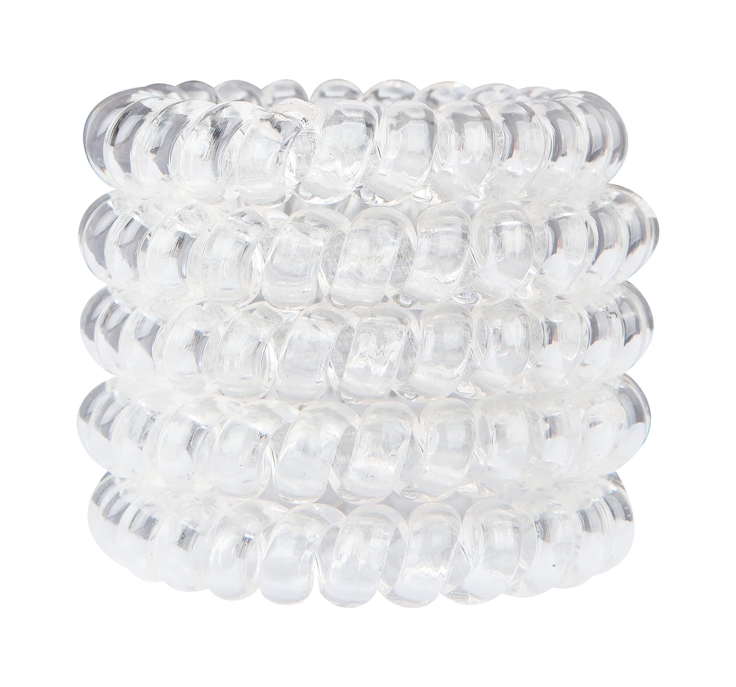 Stapel von transparenten Haargummis in Spiralform. Auf weißem Hintergrund.