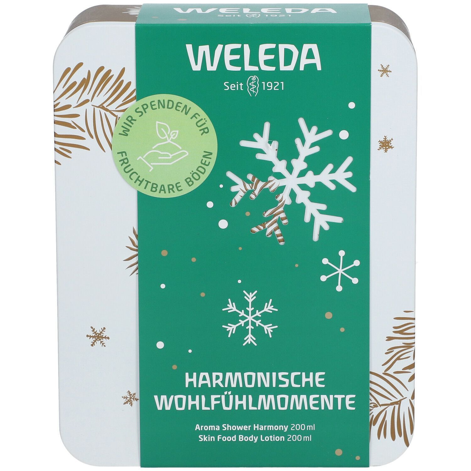 Geschenkset-Box mit grünem Deckel. Aufschrift: Weleda, Harmonische Wohlfühlmomente. Schneeflocken-Design. Seit 1921.