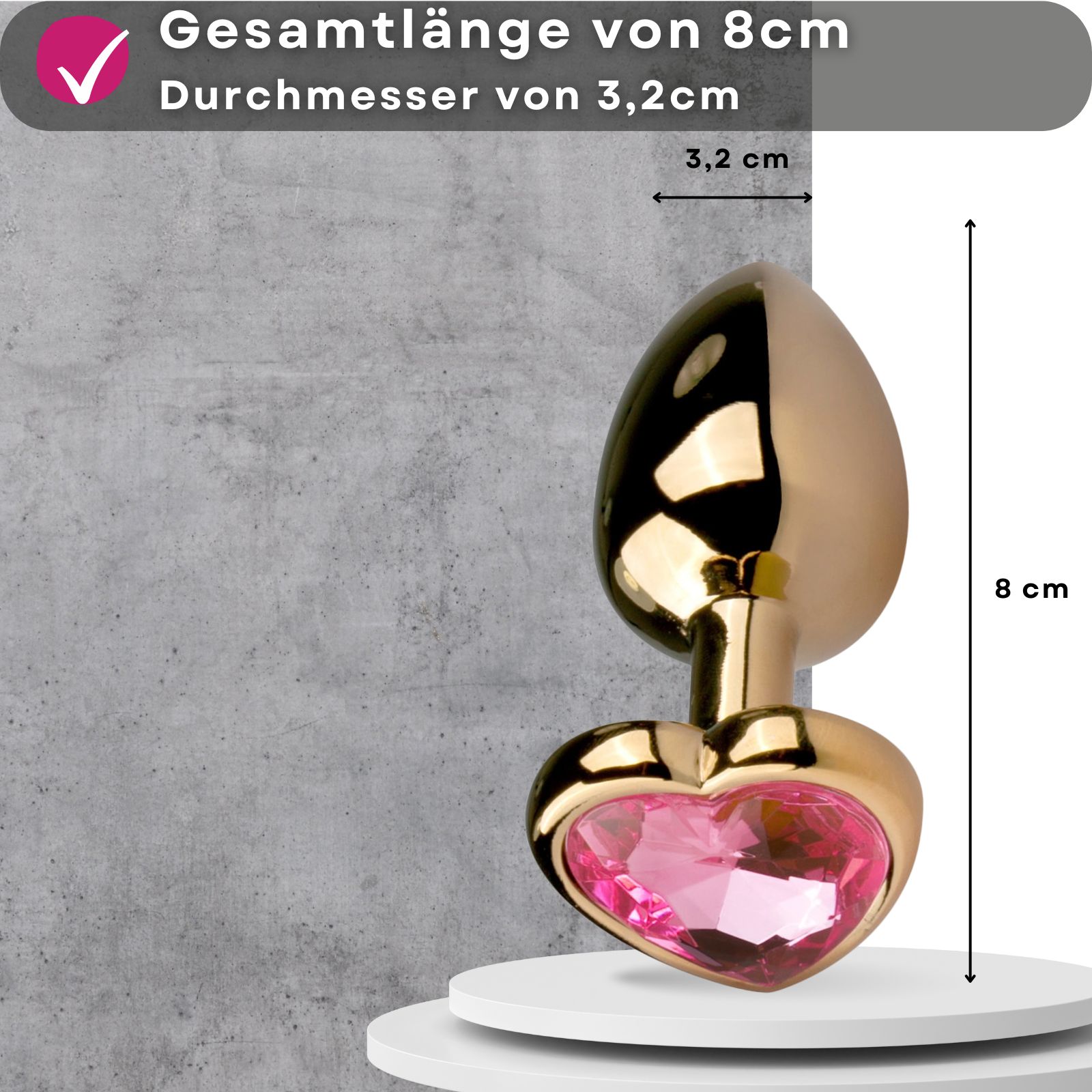 Goldfarbener Analplug mit herzförmigem Zierstein. Rosa Zierstein.