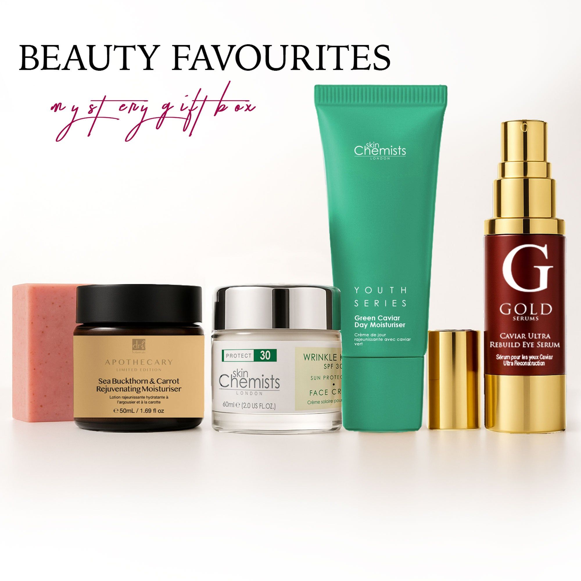 Geschenkbox mit Hautpflegeprodukten. Enthalten sind Cremes, Serum, Seife und eine Tube. Marken: SkinChemists, Apothecary, Gold Serums.