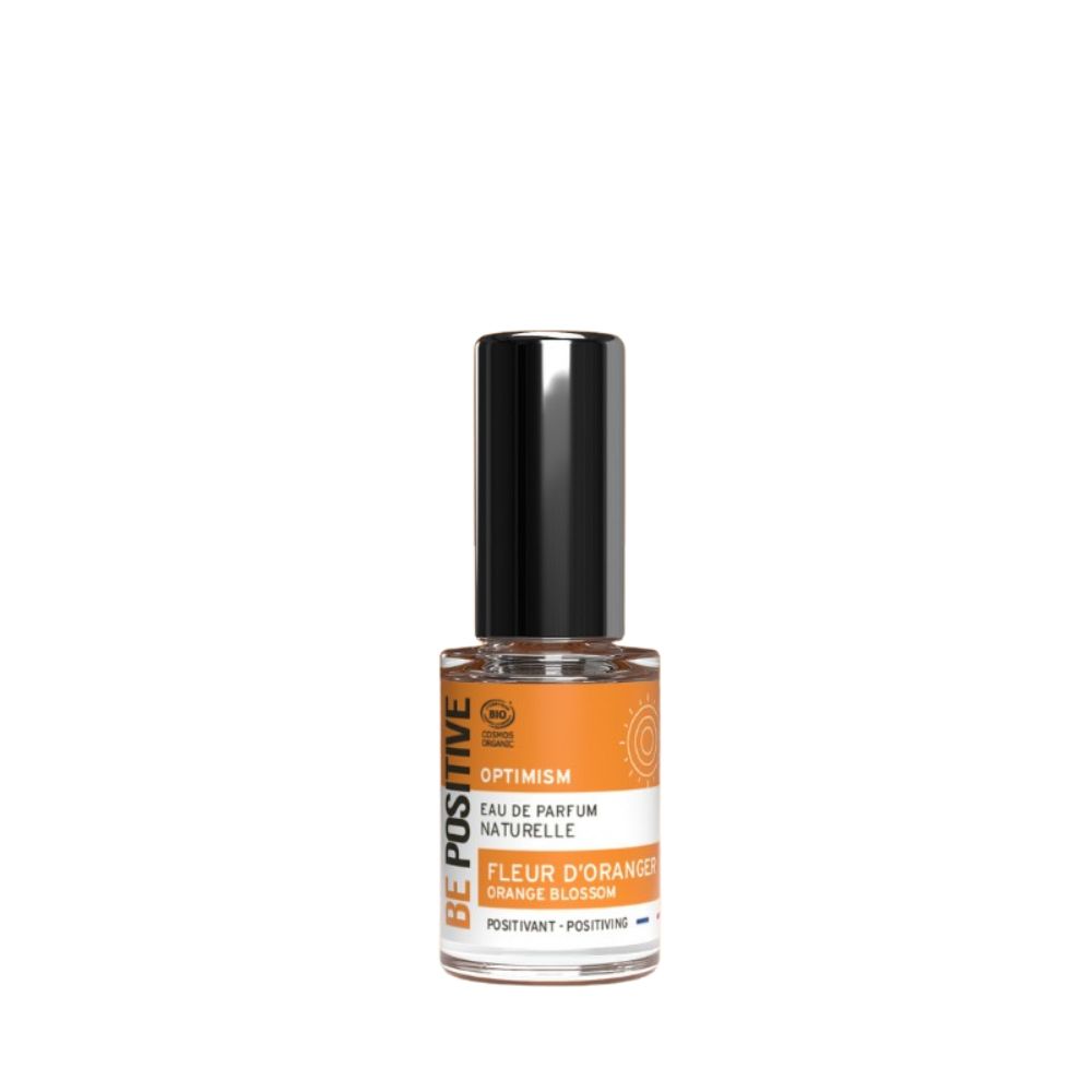 Parfümflasche mit schwarzem Deckel. Aufschrift: Optimism, Eau de Parfum Naturelle, Fleur d'Oranger, Orange Blossom.