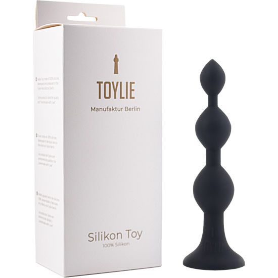 Schwarzer Anal-Dildo aus Silikon. Drei kugelförmige Elemente, konisch zulaufend. Verpackung mit "TOYLIE" und "Silikon Toy" Aufdruck.