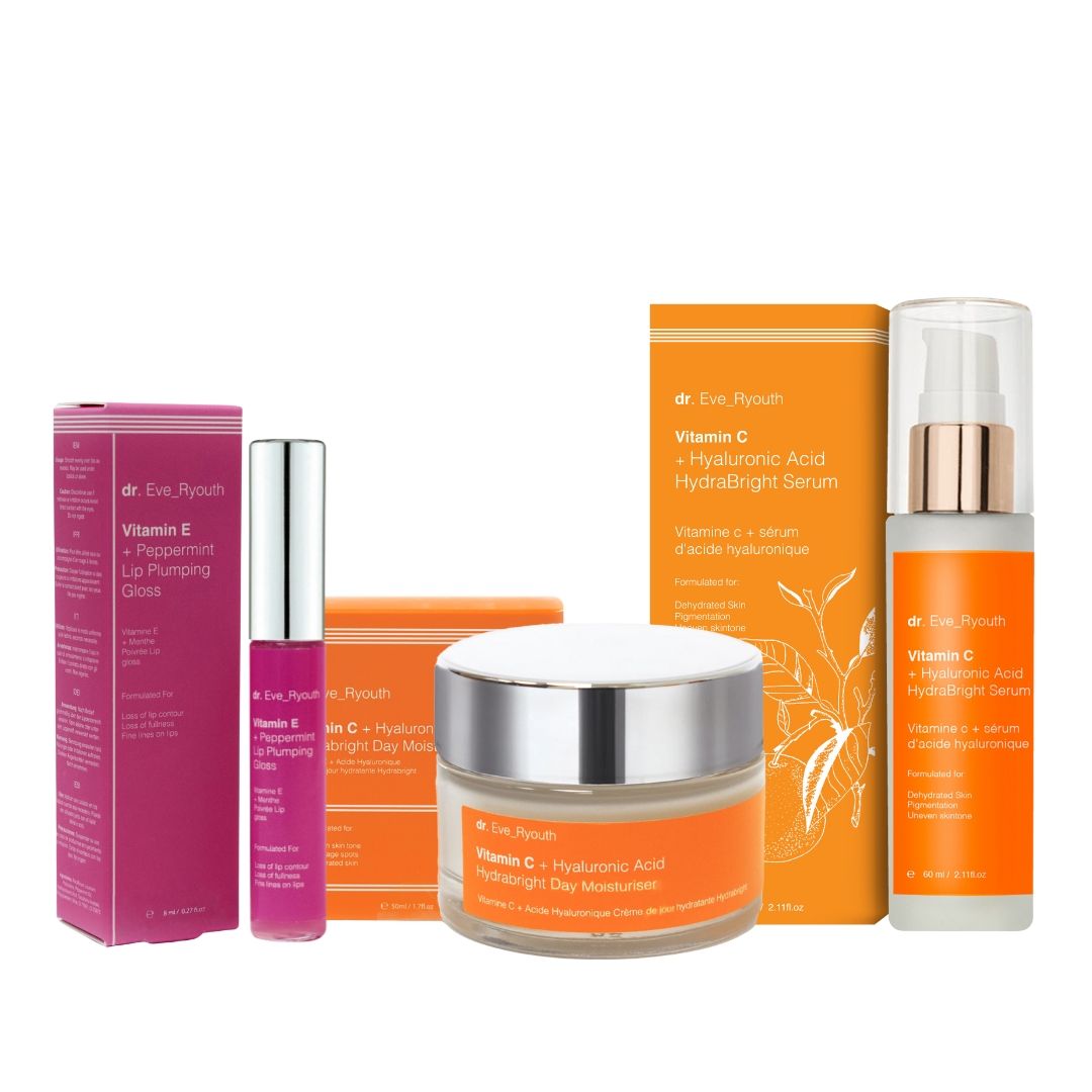 Verschiedene Kosmetikprodukte: Lippenvergrößerung, Nachtcreme und Serum. Verpackungen in Pink und Orange. Sichtbare Schriftzüge: Vitamin E, Vitamin C.