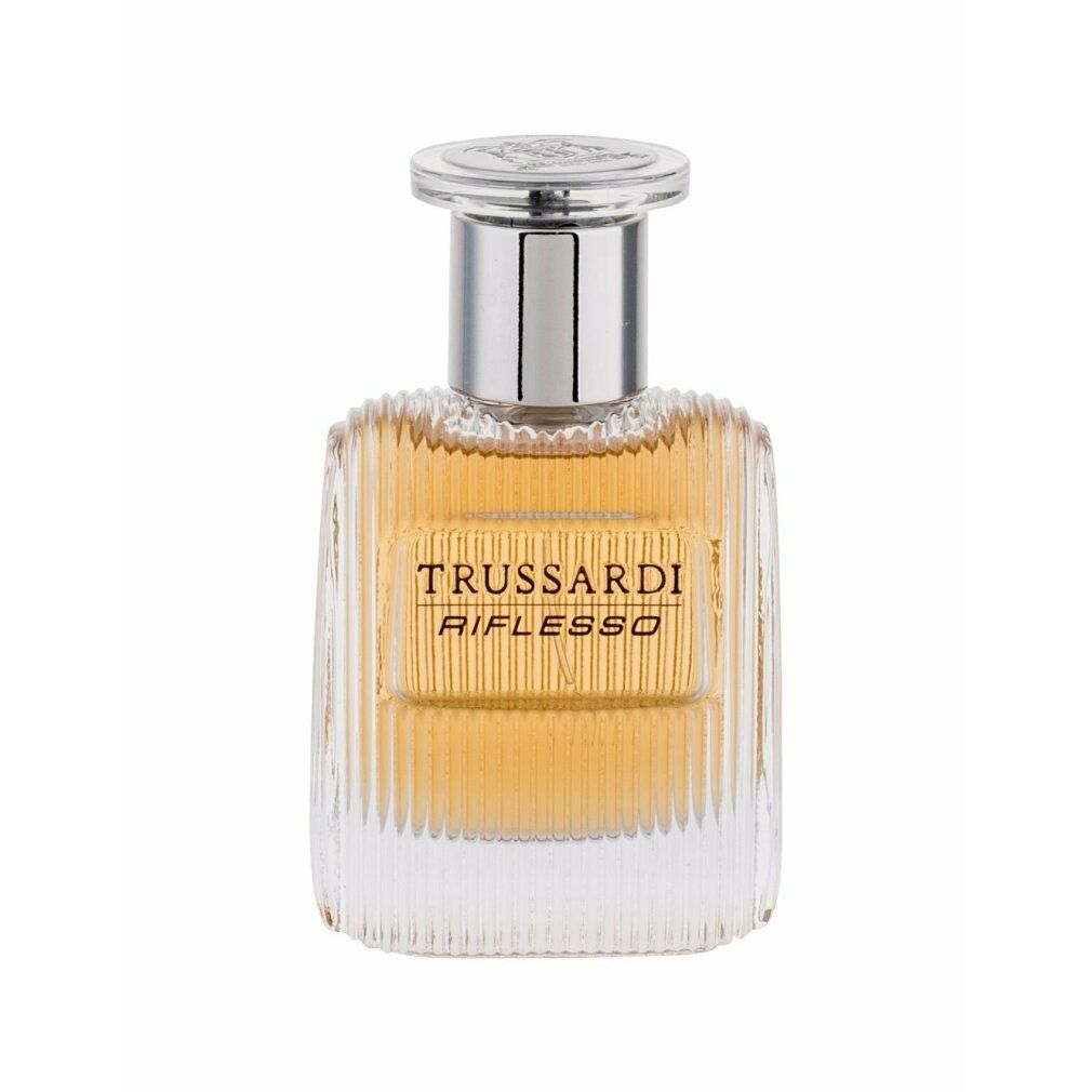 Trussardi Riflesso Eau de Toilette Spray. Transparenter Glasflakon mit geriffelter Oberfläche. Silberner Verschluss. Aufschrift: Trussardi Riflesso.