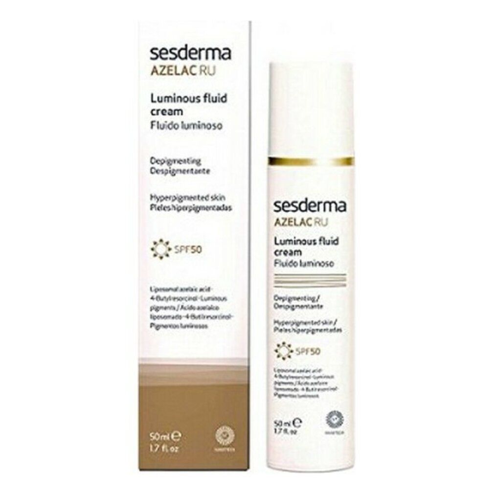 Sesderma Azelac Ru Luminous Fluid Cream und Verpackung. Weißes Fläschchen mit brauner Verpackung. Text: SPF50, Luminous Fluid Cream.