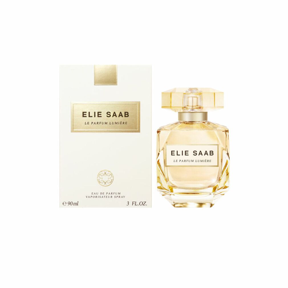 Elie Saab Le Parfum Lumiere Edp Spray und Verpackung. Weißer Karton mit goldfarbenem Logo und Flakon.