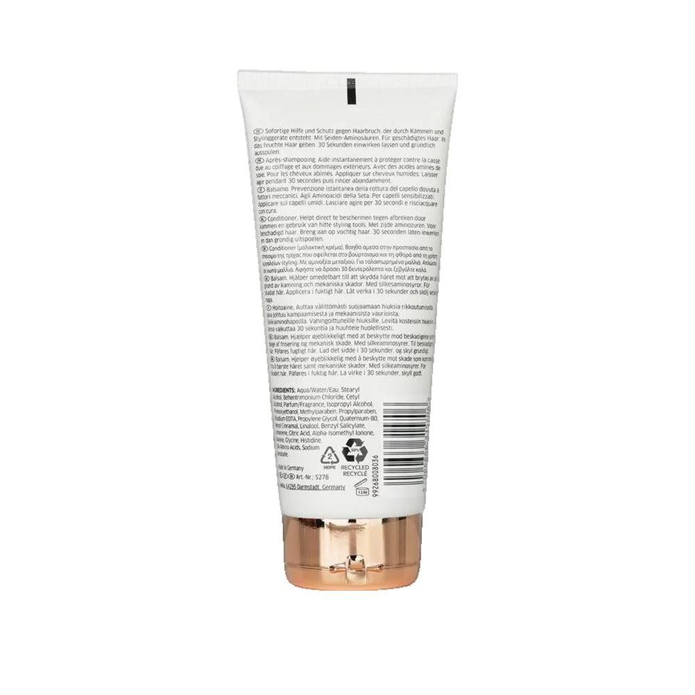 Rückseite einer weißen Tube. Text und Barcode. Kupferfarbener Boden. Recycling-Symbole.