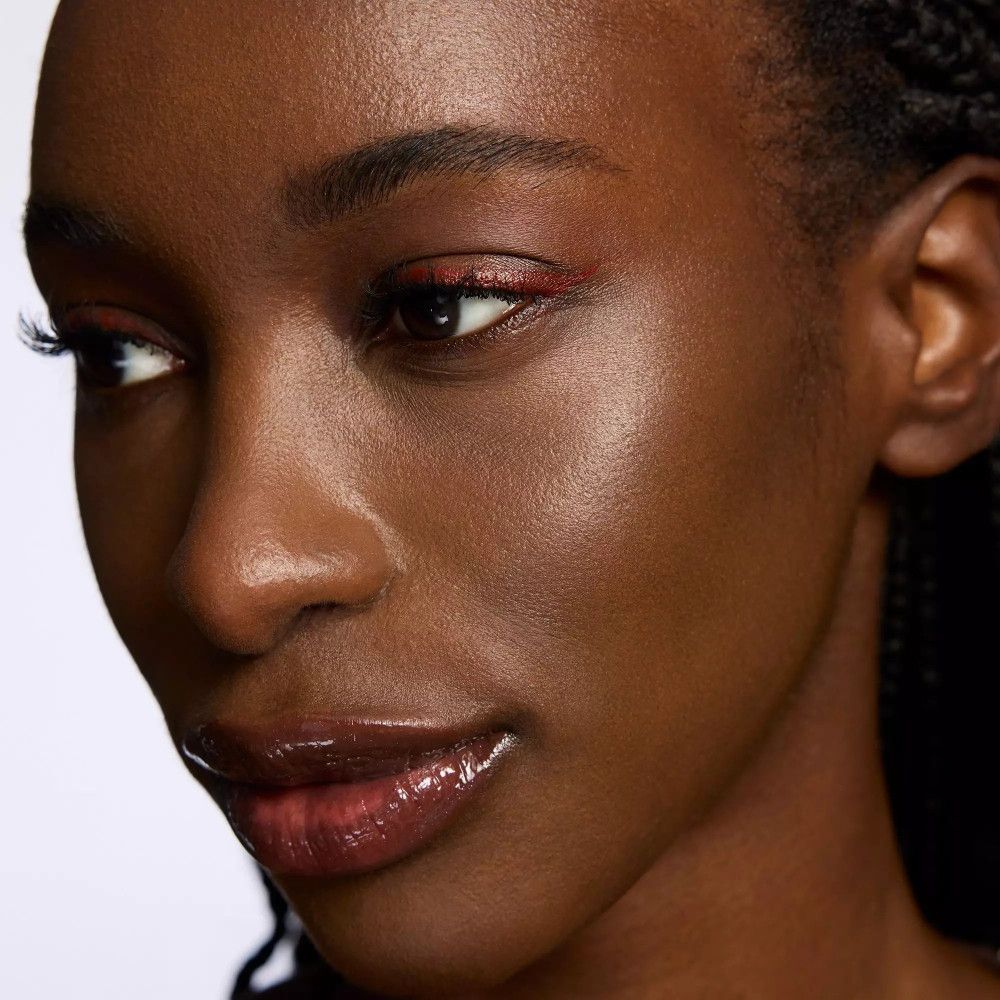 Porträt einer Frau mit rotem Eyeliner. Lippen glänzend.