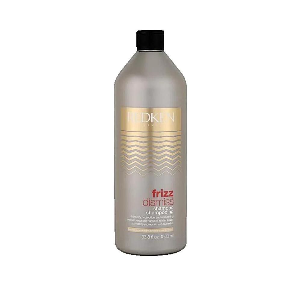 Silberne Shampoo-Flasche mit schwarzem Deckel. Aufschrift: Redken Frizz Dismiss Shampoo. Wellenmuster und Produktinformationen.