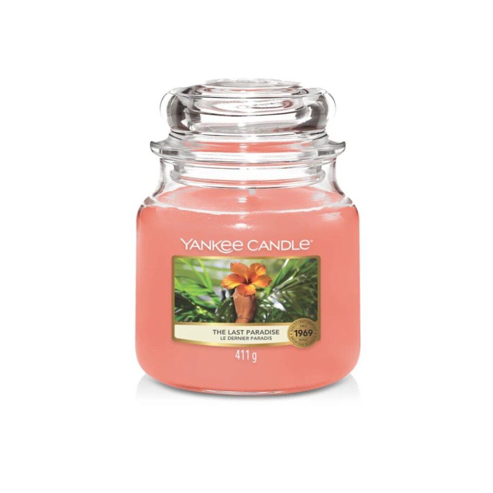 Yankee Candle Medium The Last Paradise. Rosa Kerze im Glas mit Deckel. Etikett mit Blüte und Palmen. 411g.