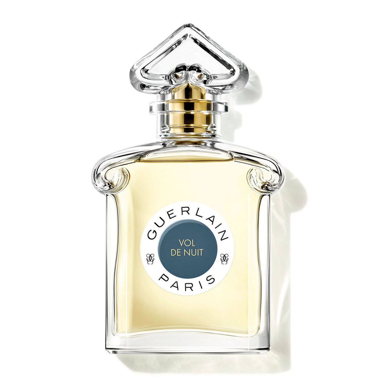Parfümflakon mit goldfarbenem Verschluss und klarer Flüssigkeit. Auf dem Etikett: Guerlain, Vol de Nuit, Paris.