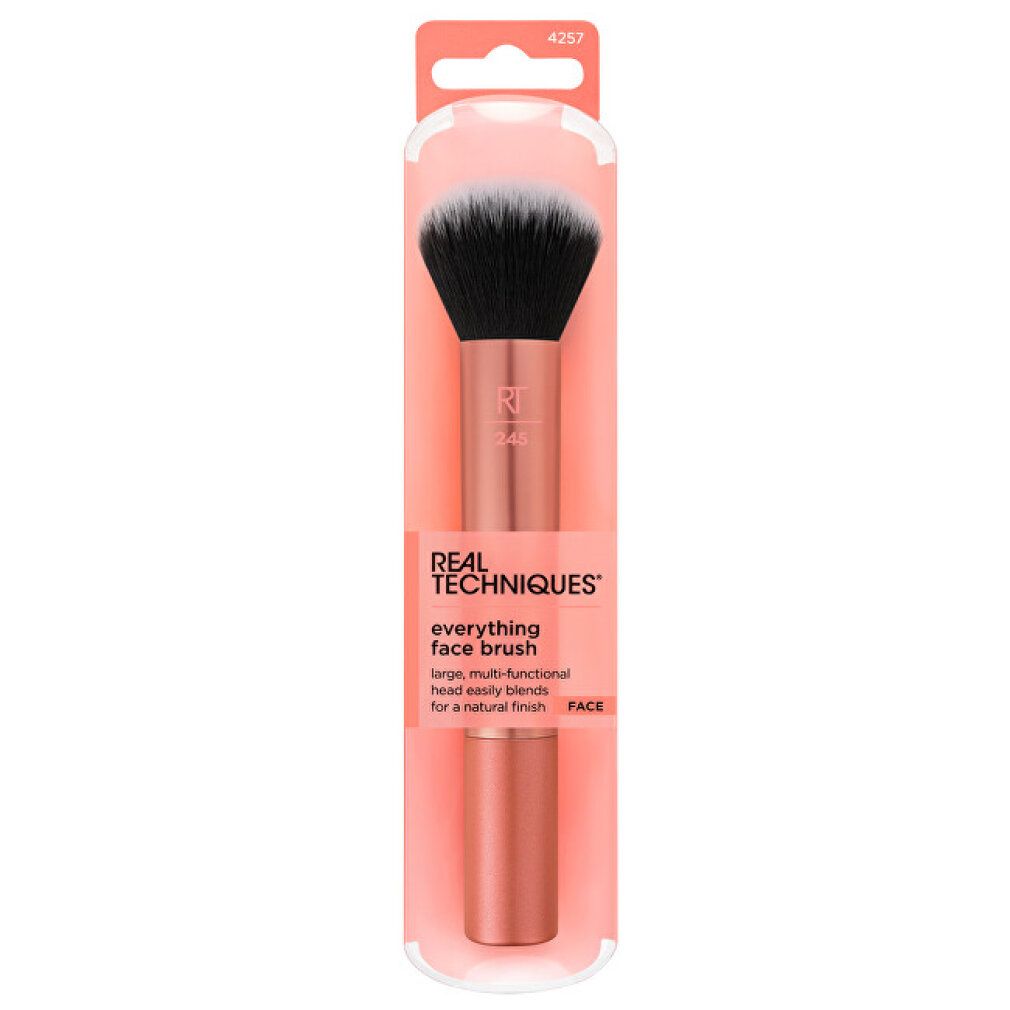 Pinsel mit schwarzem und weißem Borstenkopf, rosafarbenem Griff und Verpackung. Aufschrift: REAL TECHNIQUES, everything face brush.
