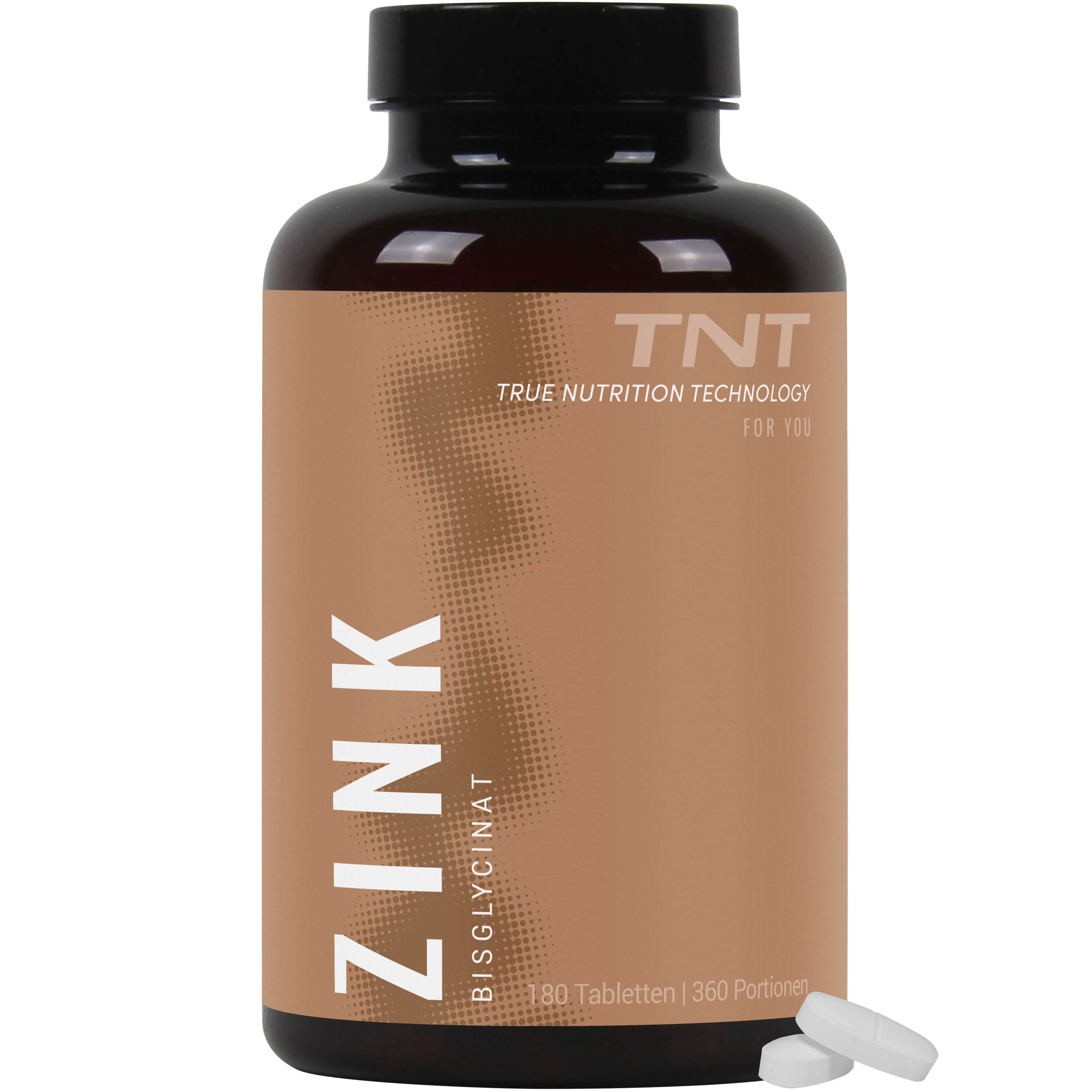 Braune Flasche mit TNT Zinkbisglycinat. Aufschrift ZINK. Zwei Tabletten liegen daneben.