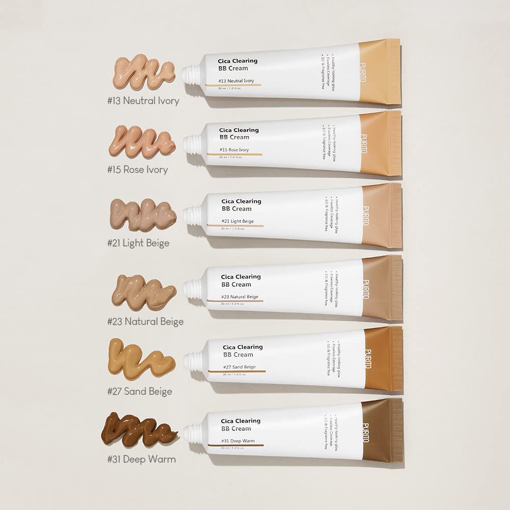 Sechs Tuben BB Cream mit Farbmustern. Farbnummern und Bezeichnungen sind sichtbar. Die Tuben sind weiß mit braunen Kappen.