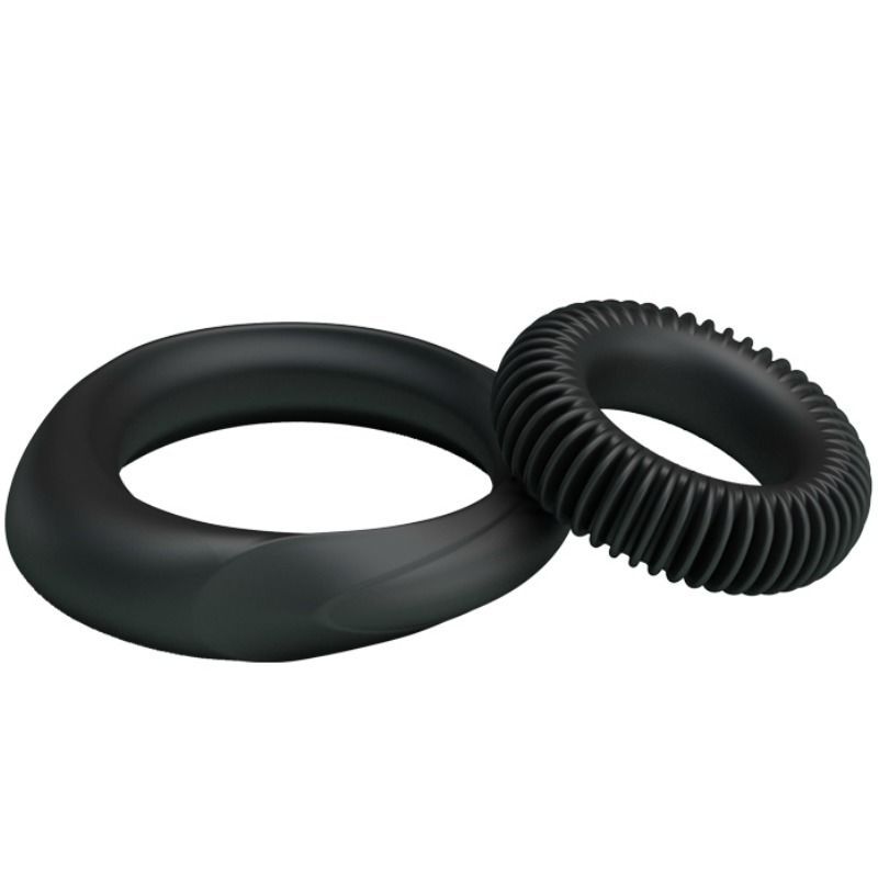 Zwei schwarze Ringe. Ein Ring mit einer erhabenen Form, der andere mit geriffelter Oberfläche. Aus Silikon.