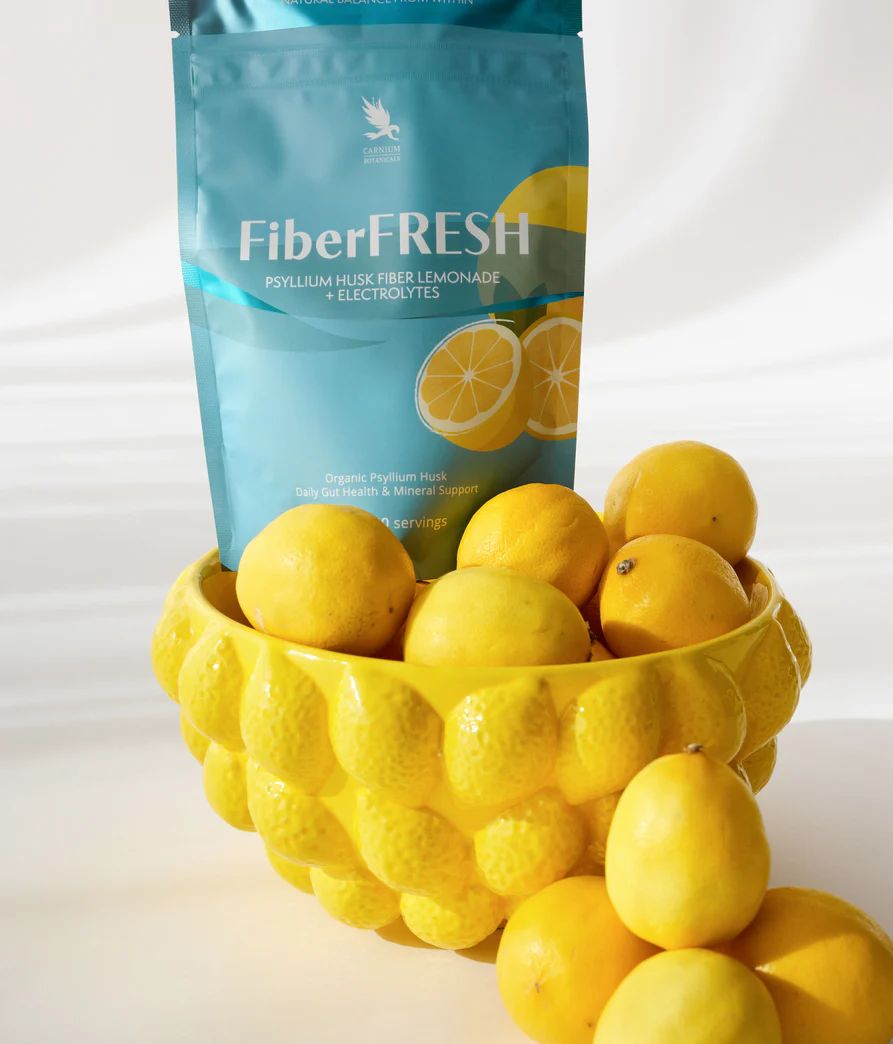 FiberFRESH-Beutel neben gelber Schale mit Zitronen. Aufschrift: Psyllium Husk Fiber Lemonade + Electrolytes.