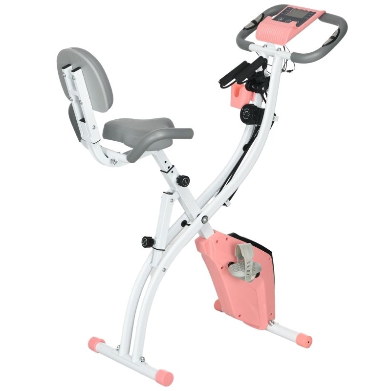 Fahrradtrainer, weiß-rosa, zusammengeklappt. Digitales Display, gepolsterter Sitz, Griffe und Pedale sichtbar.