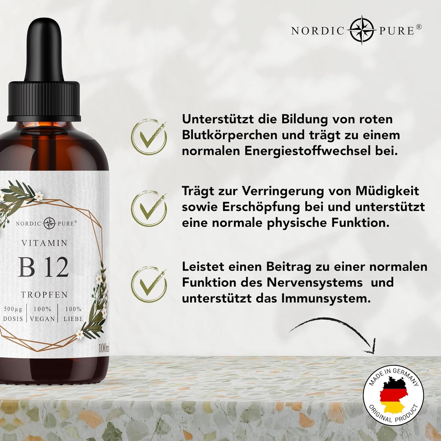 Tropfenflasche mit B12. Text: Vitamin B12 Tropfen, 500µg, 100% Vegan, 100% Liebe. Unterstützt rote Blutkörperchen, Energie, Nervensystem.