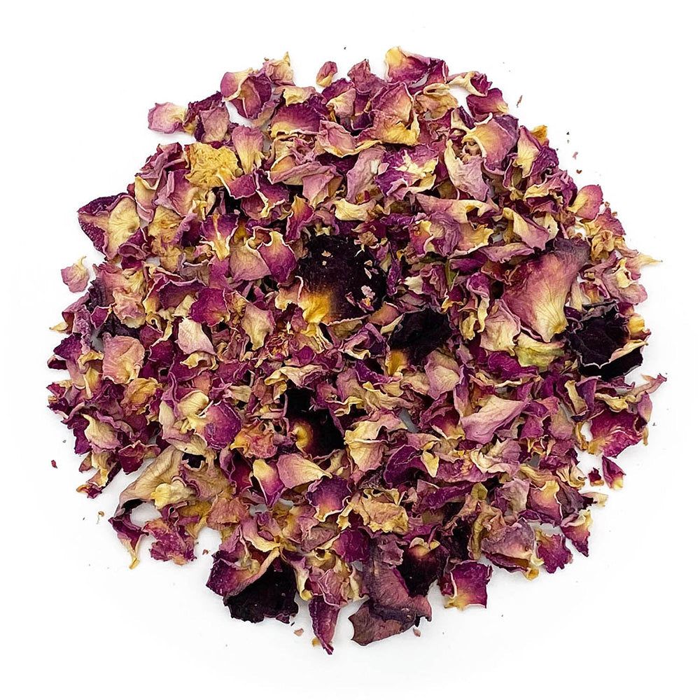 Haufen getrockneter Rosenblütenblätter. Farben: Rosa, Gelb und Braun. Auf weißem Hintergrund.