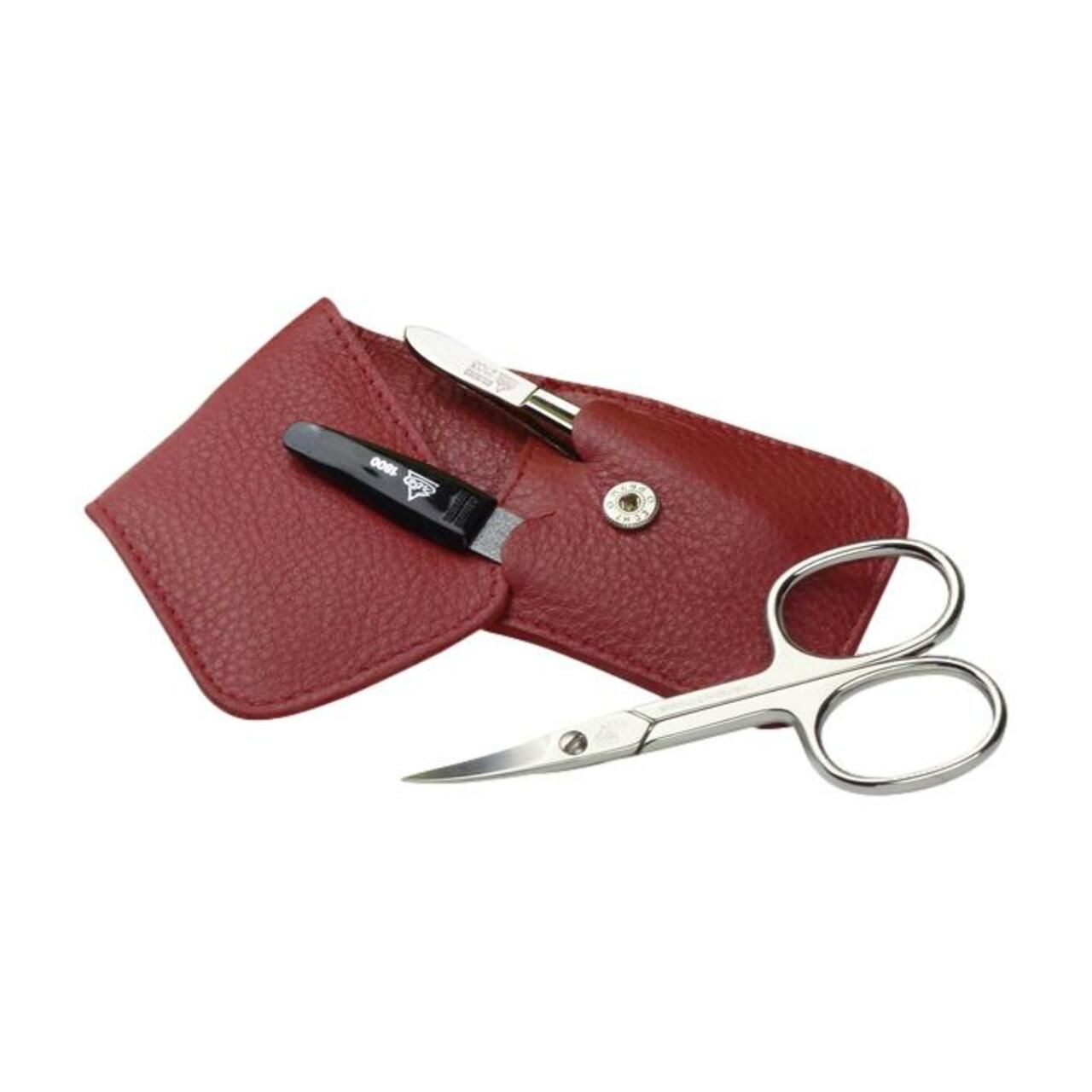 Etui mit Nagelschere, Pinzette und Nagelknipser. Rotes Lederetui mit Druckknopfverschluss. Vernickelte Schere.